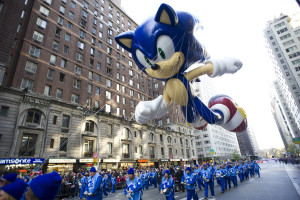 FILE - In this Nov. 22, 2012, file photo, handlers keep a tight rein on the Sonic the Hedgehog balloon as it travels the route of the Macy's Thanksgiving Day Parade in New York. Macys says it is closely monitoring the weather after recent forecasts predicted wind gusts up to 30 mph on Thanksgiving morning during the department stores upcoming Thanksgiving Day Parade. Based on New York City guidelines, no giant balloons will be operated if the wind gusts exceed 34 mph. (AP Photo/Charles Sykes, File)
